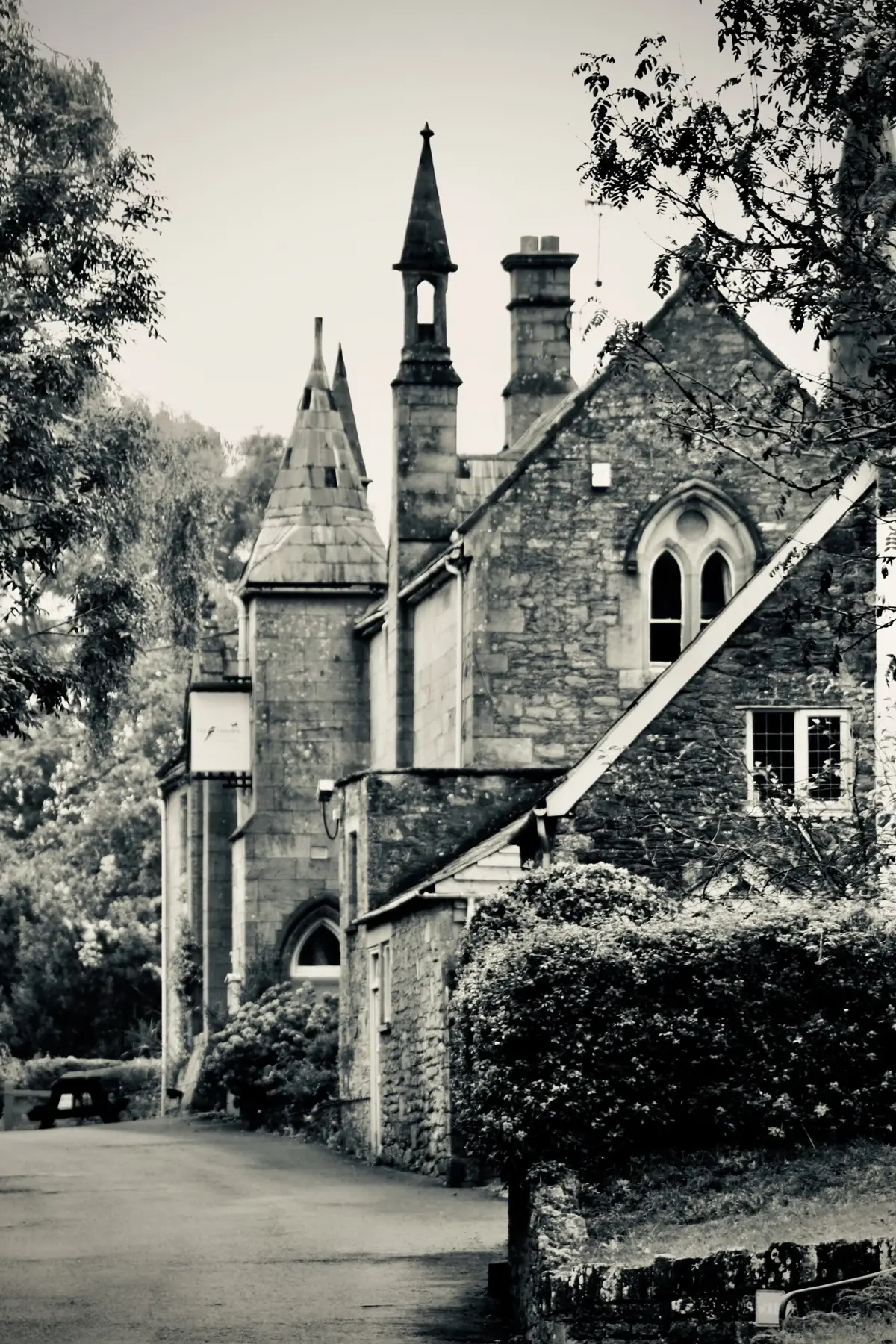 The Hostelrie at Goodrich, an 1830s stone building with a small spire, gothic-arched windows and stone tracery.